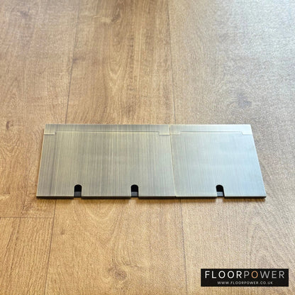 Closed Triple Recessed Floor Socket in Antique Brass on wood floor.