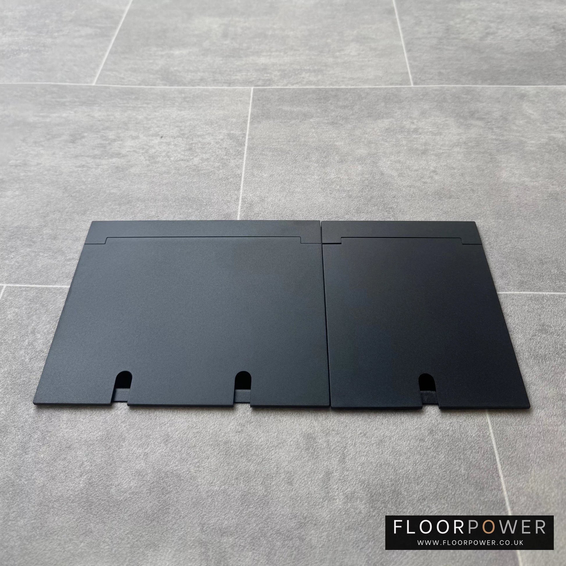 Closed Triple Recessed Floor Socket in Matt Black on tiled floor.
