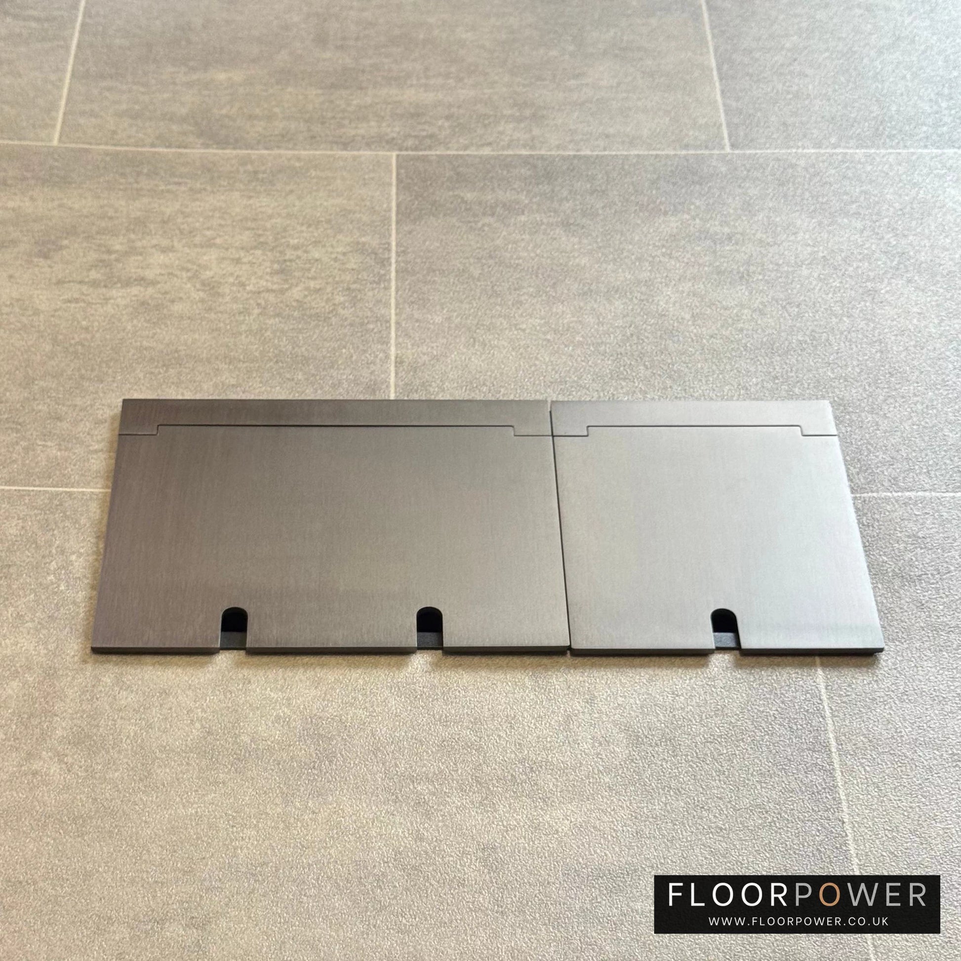 Closed Triple Recessed Floor Socket in Old Bronze on tiled floor.