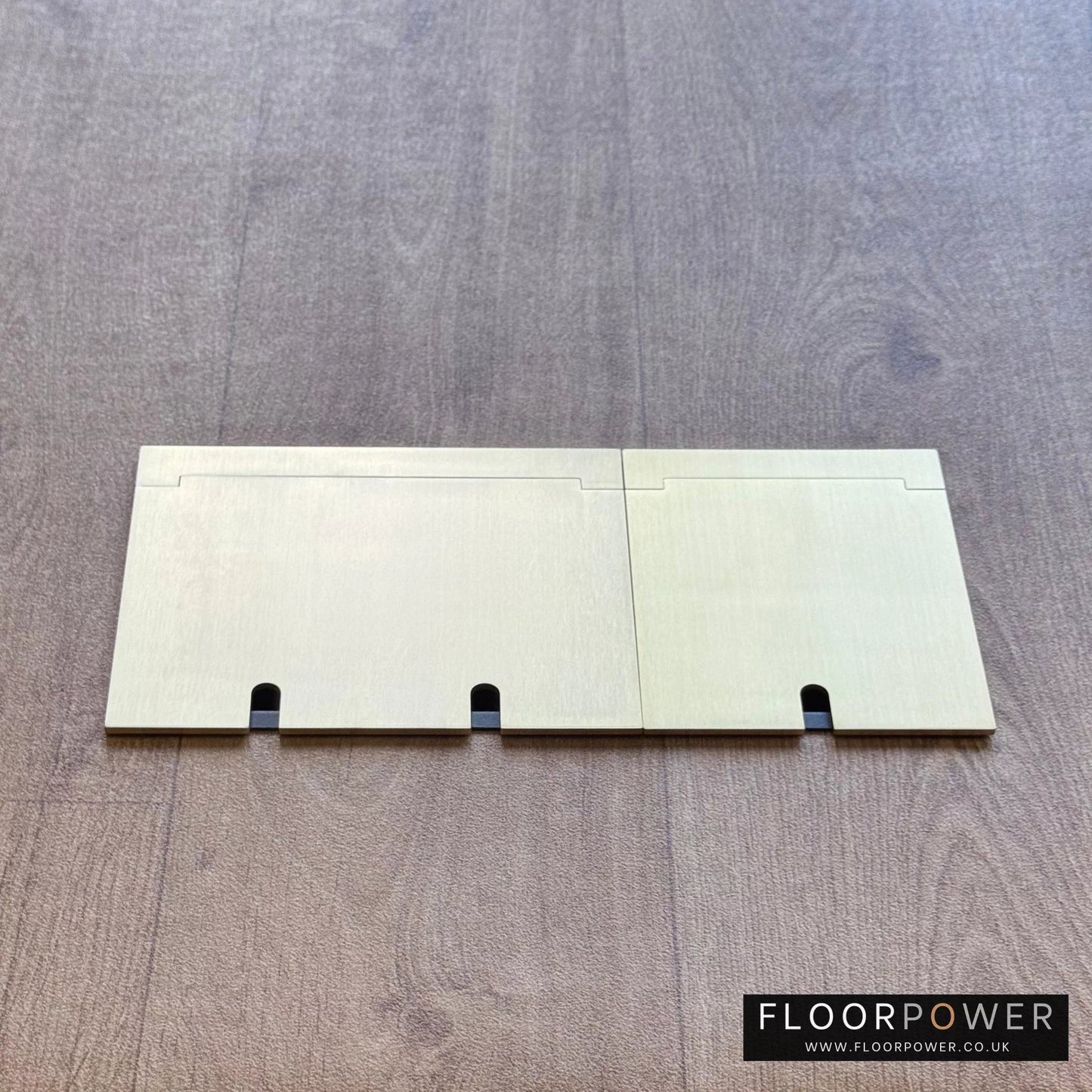 Closed Triple Recessed Floor Socket in Satin Brass on wood floor.