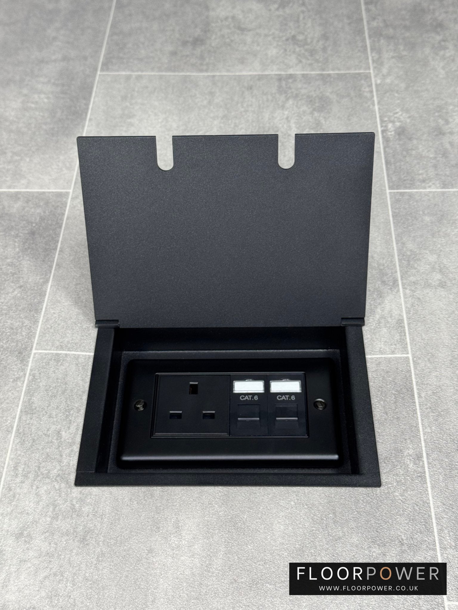 Recessed floor socket in matt black with a double box containing one 13amp unswitched socket and two RJ45 sockets.